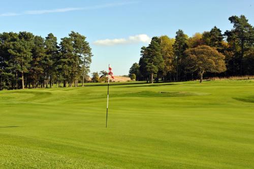 a golf course with a flag on the green at Murrayshall Country Estate in Perth