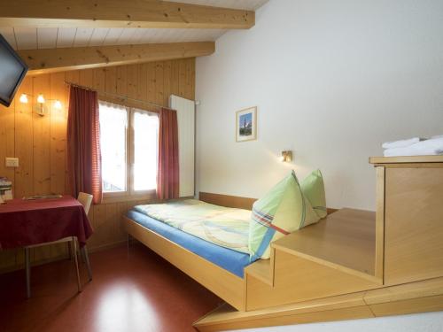 a bedroom with a bunk bed with a window at Esthers Guesthouse in Gimmelwald