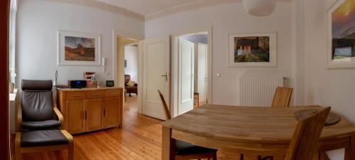 a living room with a wooden table and a dining room at Ferienwohnungen Haus am Würzlaysteig in Lehmen