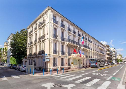 a large building on the side of a street at Hotel Busby in Nice