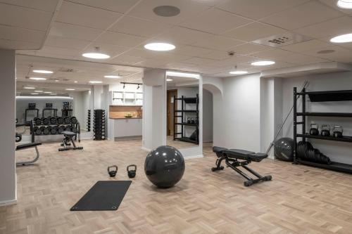 a gym with weights and exercise equipment in a room at The Sparrow Hotel in Stockholm