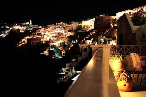a view of a city at night with lights at Keti Hotel in Fira