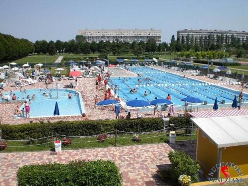 a large swimming pool with many people in it at Nice cozy apartment in the mainland of Venice in Mestre