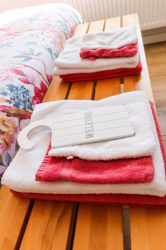 three piles of towels sitting on a bed with a knife at Bij Jans in Hilvarenbeek