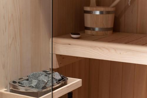 a sauna with a bowl of rocks on a shelf at Artemide Guest House in Florence