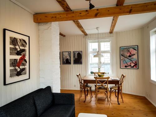 a living room with a table and a couch at House of the Snowbird in Reykjavík