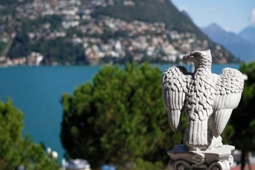 a statue of an eagle sitting on top of a building at Hotel Victoria in Lugano