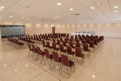 a room with rows of chairs and a table in it at Gran Bourbon Hotel Asuncion in Asuncion