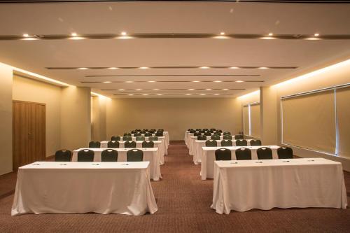 a conference room with white tables and chairs in it at Gran Bourbon Hotel Asuncion in Asuncion