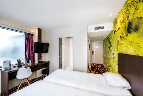 a bedroom with a white bed and a yellow wall at ibis Styles Saint Julien en Genevois Vitam in Neydens