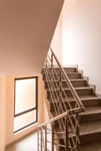 a staircase in a house with a window at Bečiči - Andrea apartman in Becici