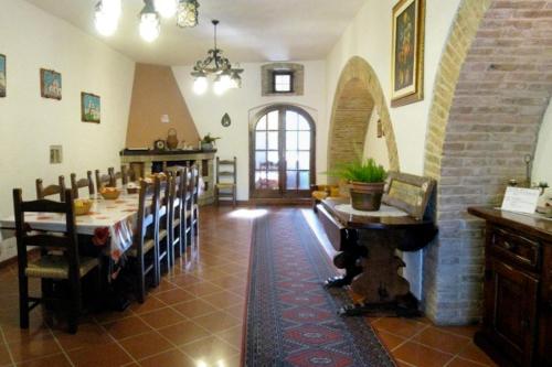 a large dining room with a table and chairs at Agriturismo La Cantina in Bastia Umbra