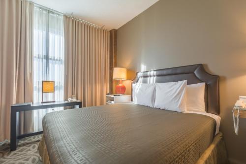 a hotel room with a bed and a window at Proximity Hotel in Greensboro