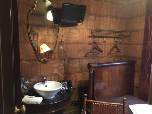 a bathroom with a sink and a mirror at Pavilion Hotel in London