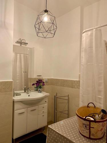 a bathroom with a sink and a mirror at Corso Vittorio Emanuele Luxury house in Salerno