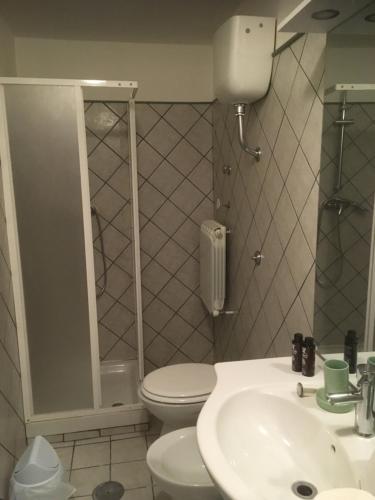 a bathroom with a toilet and a sink at Pretoria House in Potenza