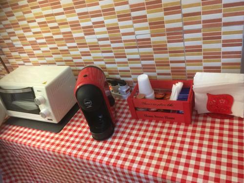 a table with a toaster a toaster and a box at Pretoria House in Potenza