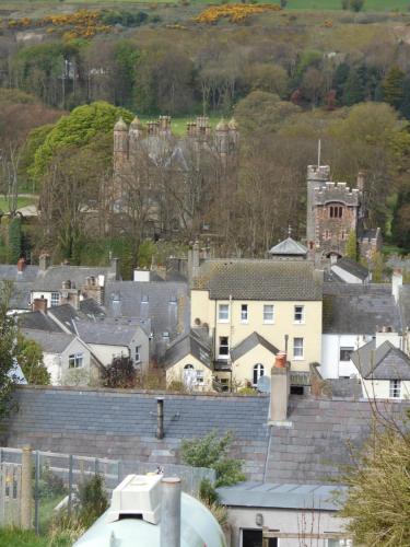 a city with houses and a castle in the background at The Barn at BallyCairn in Larne