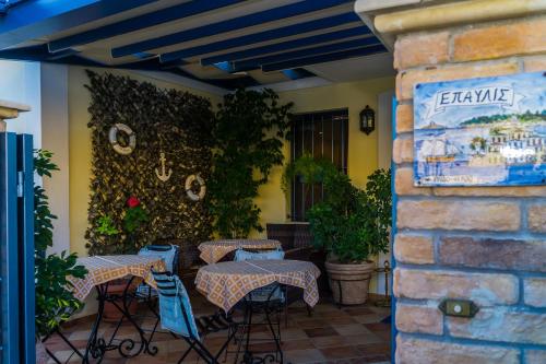 a patio with tables and chairs on a patio at ''EPAVLIS boutique GALAXIDI'' in Galaxidhion
