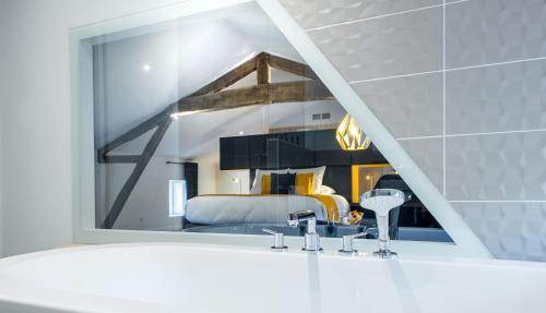 a bathroom with a mirror above a white sink at le tilia in Joux