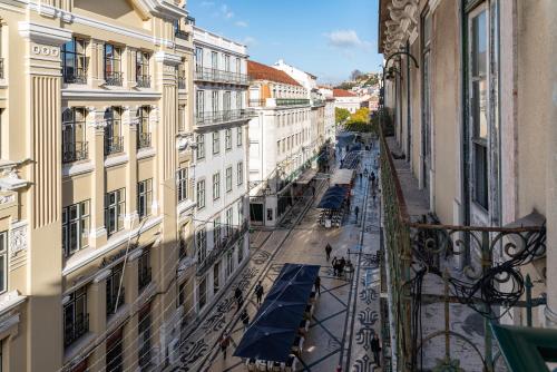a view of a city street from a balcony at Be Poet Baixa Hotel in Lisbon