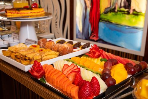 a buffet filled with different types of fruit and pastries at Be Poet Baixa Hotel in Lisbon