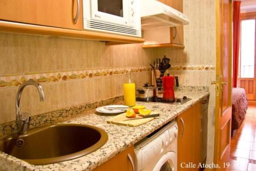 eine Küche mit einer Spüle und einer Arbeitsplatte in der Unterkunft Apartamentos Madrid in Madrid