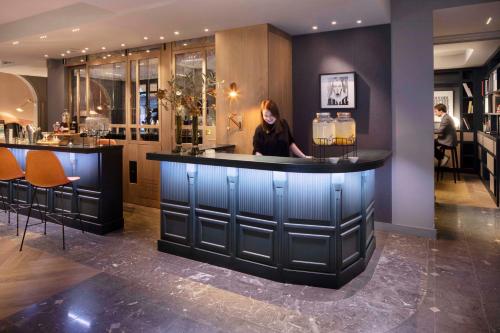
a kitchen with a large counter top and a large window at Hotel Flanelles Paris in Paris
