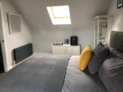 a bedroom with a large bed and a skylight at City Centre Townhouse-3 Bedrooms & Parking - Excellent Location in Belfast