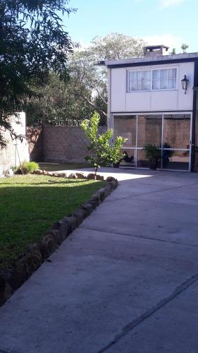 a house with a driveway leading to a building at Alojamiento independiente. Salto, Uruguay in Salto