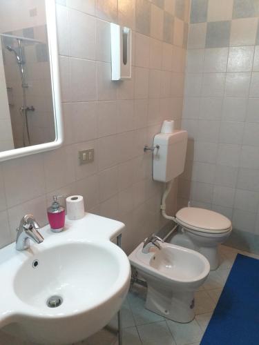 a bathroom with a sink and a toilet and a mirror at Hotel Arcella in Padova