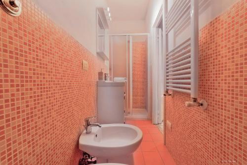 a bathroom with a white toilet and a shower at Wine Apartments Florence Colorino in Florence