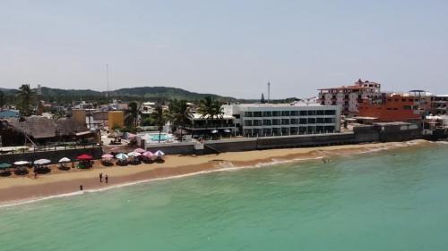 a view of a beach with umbrellas and the ocean at Hotel Barra de Navidad in Barra de Navidad