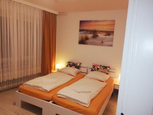 two twin beds in a room with a window at The Hostel in Hamburg