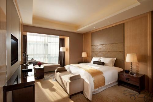 Ένα ή περισσότερα κρεβάτια σε δωμάτιο στο Wanda Realm Langfang
