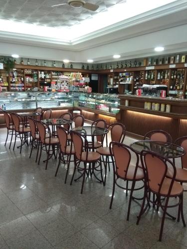 a room with tables and chairs in a restaurant at Residencial Real - Antiga Rosas in Vila Real