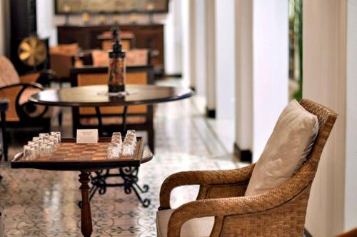 a chess board on a table in a room with chairs at Ping Nakara Boutique Hotel And Spa in Chiang Mai