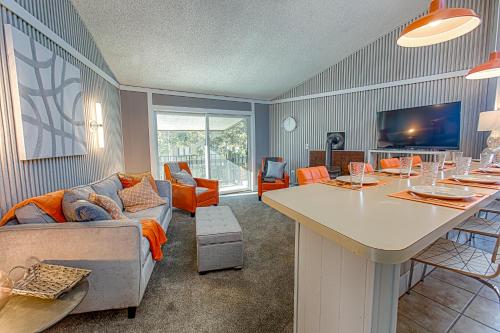 a living room with a couch and a table at Gold Camp Gold Pan Condo: On Shuttle Route in Breckenridge