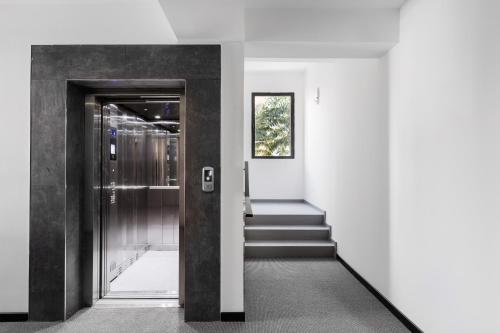 a hallway with a door and stairs in a building at G Suites Luxury Rentals in North Nicosia