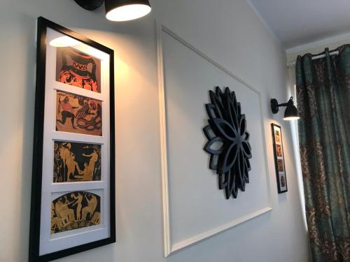 a hallway with two framed pictures on a wall at Apartamenty Blisko Centrum in Toruń