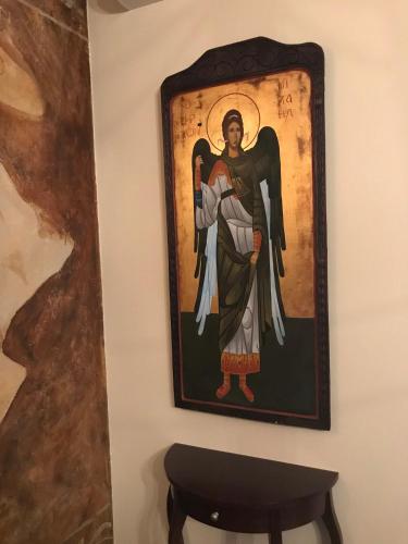 a painting of builder hanging on a wall at Apartamenty Blisko Centrum in Toruń