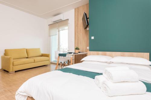 A bed or beds in a room at Pantheon Square View Komotini