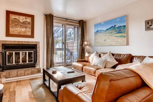 a living room with a couch and a fireplace at Cedar Lodge Peak One Studio Condo: Downtown Frisco in Frisco