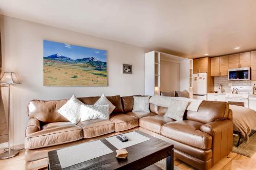a living room with a couch and a table at Cedar Lodge Peak One Studio Condo: Downtown Frisco in Frisco
