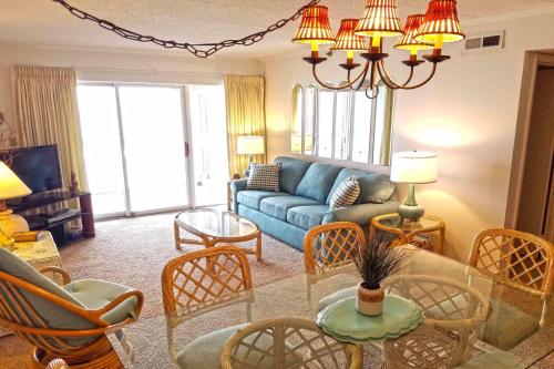 a living room with a blue couch and chairs at Sungate 402 in Ocean City