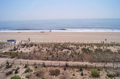 an aerial view of a beach with people riding horses at Sungate 402 in Ocean City
