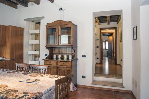 a kitchen with a table and a wooden cabinet at Residence Villa Vinco in Tregnago