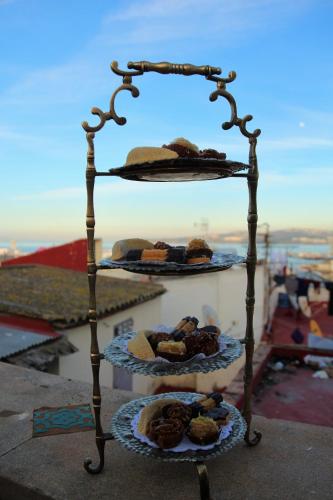 a rack of pastries on plates on a balcony at Palais Zahia Hotel & Spa in Tangier