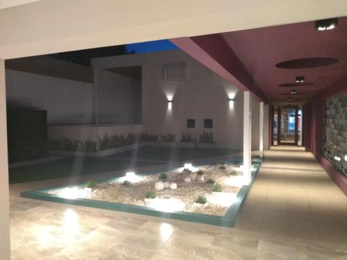 a pool in the middle of a building with lights at garden33 in Chivilcoy