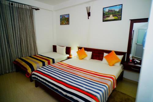 a hotel room with two beds and a window at Airport 4 Season Transit Hotel in Katunayake